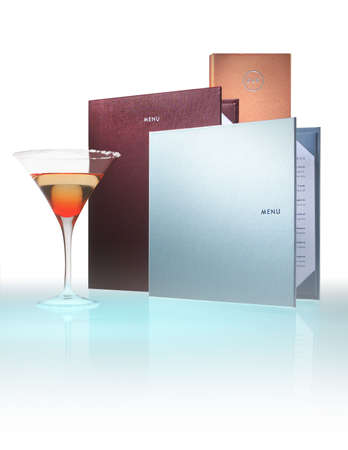 Menus on reflective white with cocktail glass alongsideの写真素材