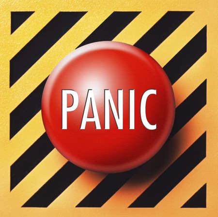 Panic button in red on orange and black backgroundの写真素材