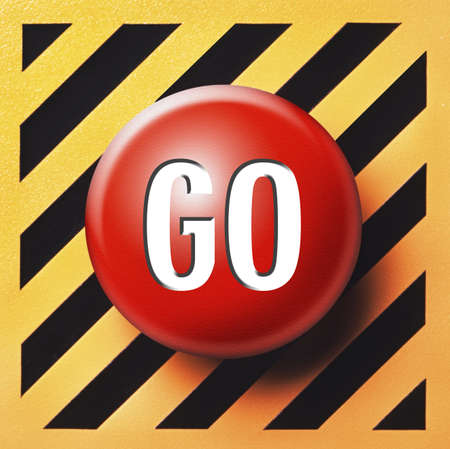 Red GO button on yellow and black panelの写真素材
