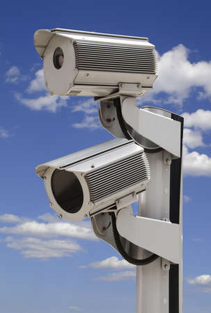 Two security surveillance cameras on blue skyの写真素材