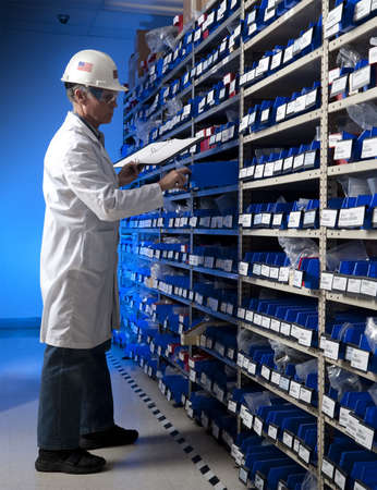Factory Worker taking inventory in stock room of a manufacturing companyの写真素材