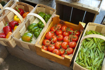 Assorted vegetables in baskets at a farmers market の写真素材