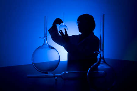 Silhouette of a female researcher carrying out research in a chemistry labの写真素材