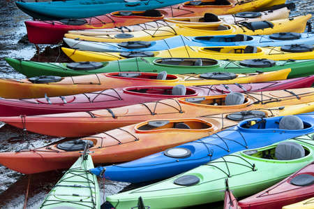 Colorful fiberglass kayaks tethered to a dock as seen from aboveの写真素材
