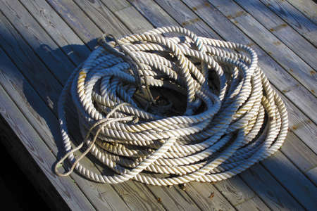 Coiled nautical rope on a boat dockの写真素材