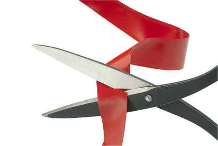 Scissors cutting through red tape as a metaphor or concept for problem solvingの写真素材