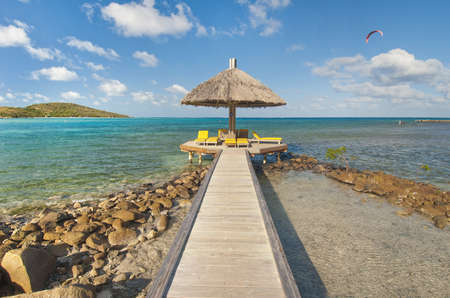 Pier leading to cupola lounging area in caribbean watersの写真素材