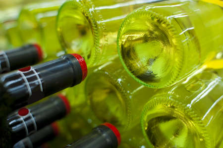 White wine bottles stacked upの写真素材