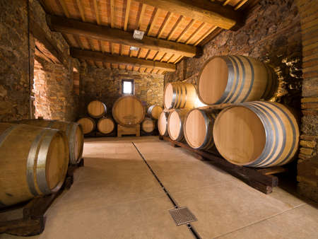 oak wine barrels stacked in a winery cellarのeditorial素材