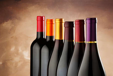 red wine bottles in a row on old master s canvasの写真素材