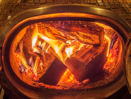 Wood stove with logs burning insideの写真素材