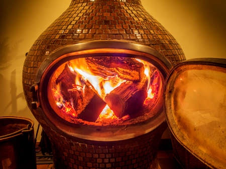 Wood stove with logs burning insideの写真素材