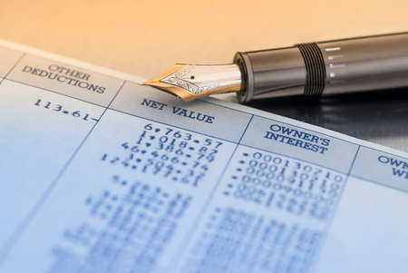 Financial report with pen and data sheetの写真素材