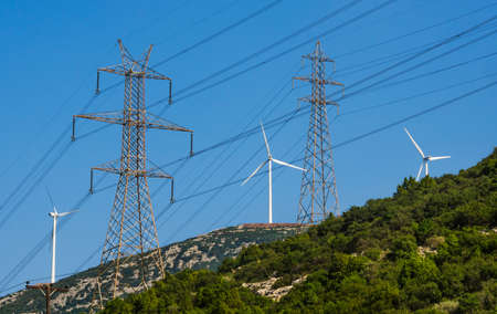 Wind turbines and high voltage electricity towersの写真素材