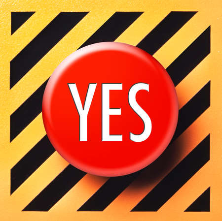 Yes button in red on a yellow and black backgroundの写真素材