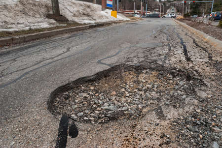 Big pothole in roadの写真素材