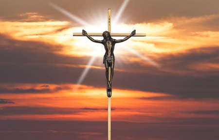 Jesus Christ passion on the cross at sunsetの写真素材