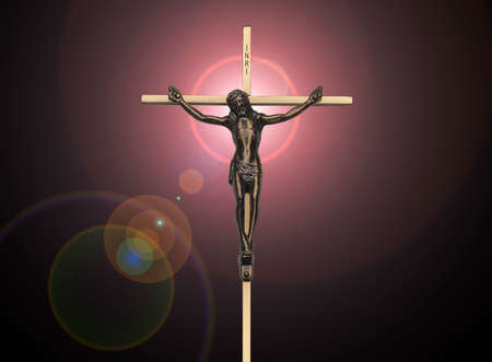 Jesus Christ passion on the cross on black with pink lens flareの写真素材