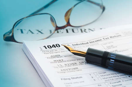 Tax accounting 1040 US Tax Form, with  pen and glassesの写真素材