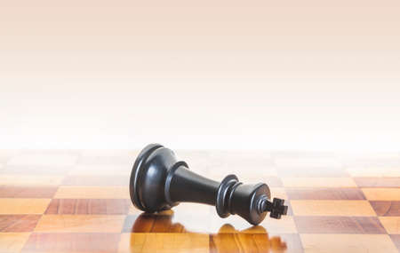 Fallen chess king as a metaphor for fall from powerの写真素材