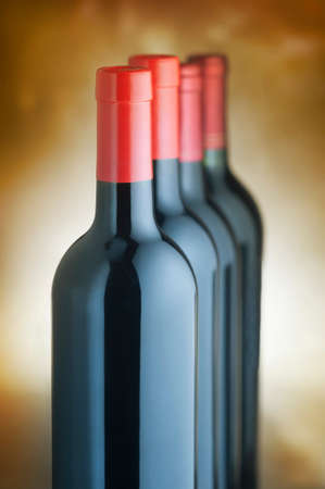 Red wine bottles stacked verticallyの写真素材