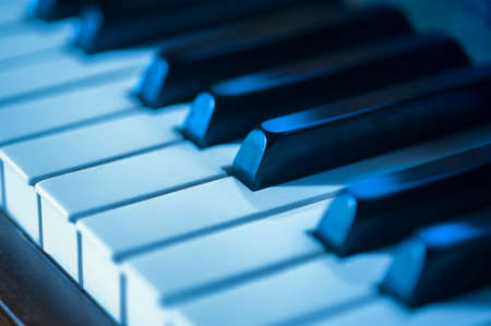 Close-up of piano keys in blues as a concept for jazzの写真素材
