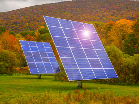 Solar panels in nature surrounded by fall foliageの写真素材