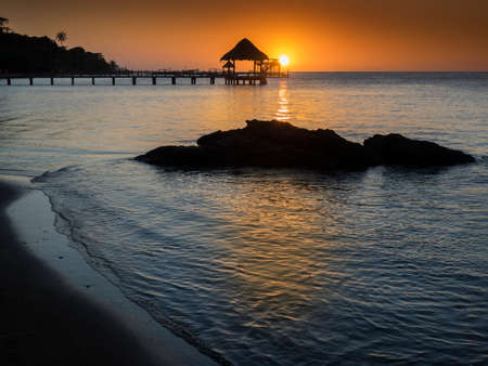 Sunset on the tropical island of Roatan, Hondurasの写真素材
