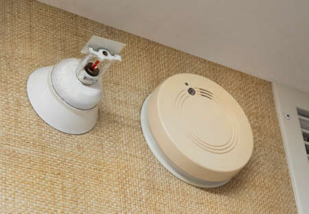 Fire sprinkler and alarm on hotel room wallの写真素材