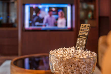 Ready to watch TV with bowl of pop corn and remoteの写真素材