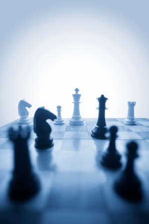 Chess pieces on board in blues, vertical format with room for type at the topの写真素材