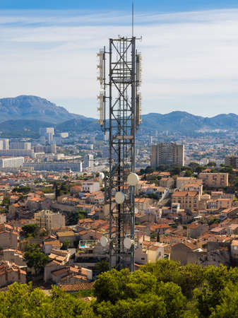Cell phone tower over a town in southern Franceの写真素材