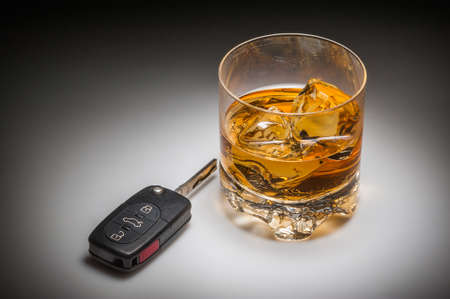 Drinking and driving concept with whiskey and car keysの写真素材