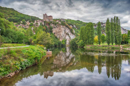 The medieval town of Saint-Cirq Lapopie, with thirteen listed historic buildings, is one of the most beautiful villages in France. Perched on a cliff three hundred feet above the river Lot, St. Cirq Lapopie is one of the most important sites in the Lot Vaのeditorial素材