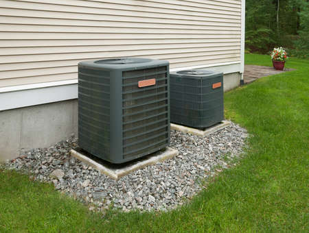 Heating and air conditioning units in back of an apartment complexの写真素材