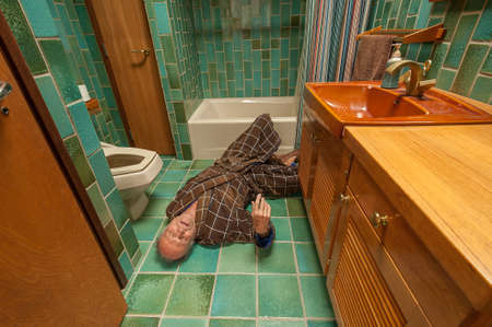 Senior man falling in a bathroomの写真素材