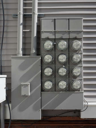 Electric power meters to apartments on the outside wallの写真素材
