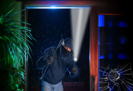Burglar just pried open a sliding glass door into a residential houseの写真素材
