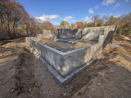 New concrete house foundation on a lot in the city suburbsの写真素材