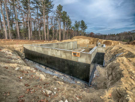 New concrete house foundation on a lot in the city suburbsの写真素材
