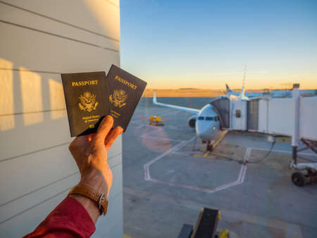 Airline traveler holding passports at airportの写真素材