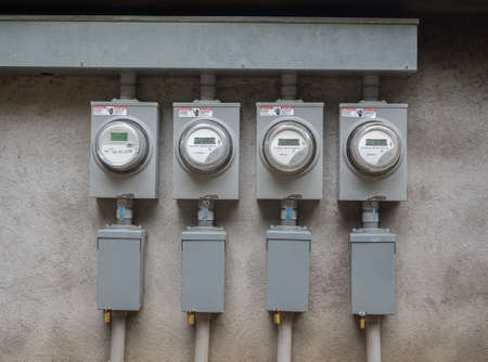 Outdoor electricity meters on the side of an apartment complexのeditorial素材
