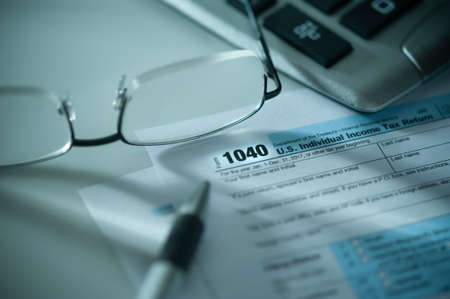 tax form with pen calculator and glasses ** Note: Shallow depth of fieldの写真素材