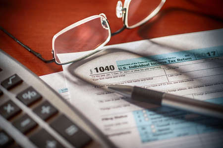 tax form with pen calculator and glasses ** Note: Shallow depth of fieldの写真素材