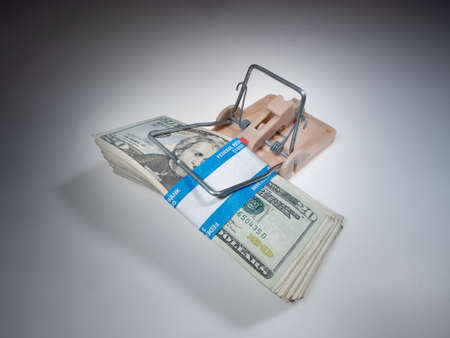 Money as bait in a trap that attracts people that will do foolish thingsの写真素材