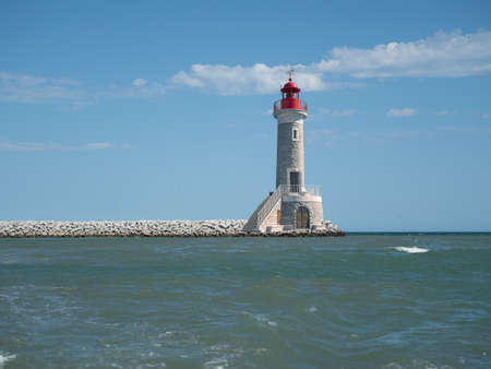 Solitary navigation lighthouse at pier end.の写真素材