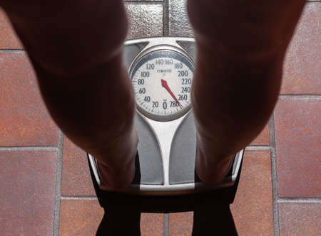 Fat person weighing themselvesの写真素材