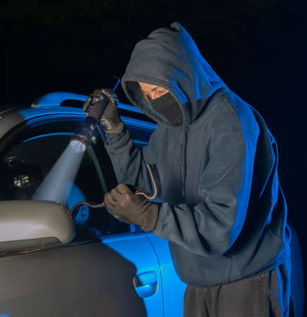 Thief and robber trying to hijack the car or steal inside belongingsの写真素材