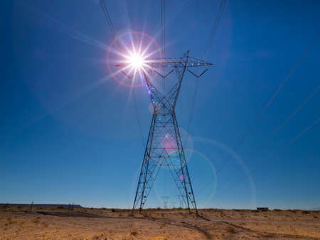 High voltage electricity power lines at sunsetの写真素材