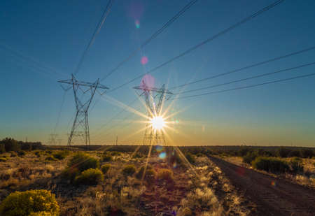 High voltage electricity power lines at sunsetの写真素材